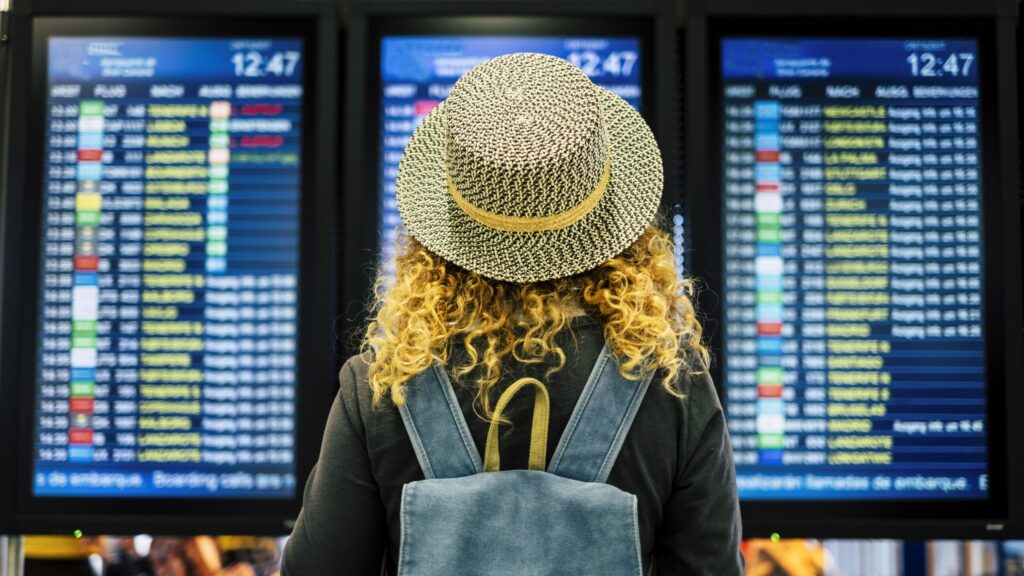 Travel people in airport or train station concept - view from rear
